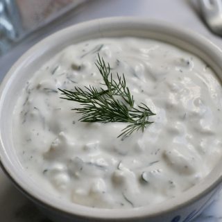 Easy Greek Dip with Feta in a small bowl on a white counter top.
