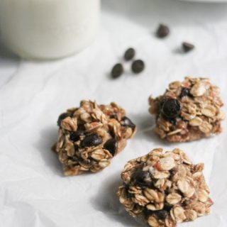 Healthy 3-Ingredient Sweet and Salty Oat Cookies on parchment paper with a glass of milk