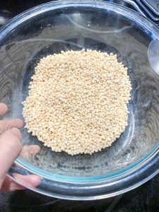 A clear bowl filled with puffed quinoa