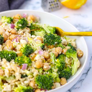 Broccoli rice salad on a white plate.