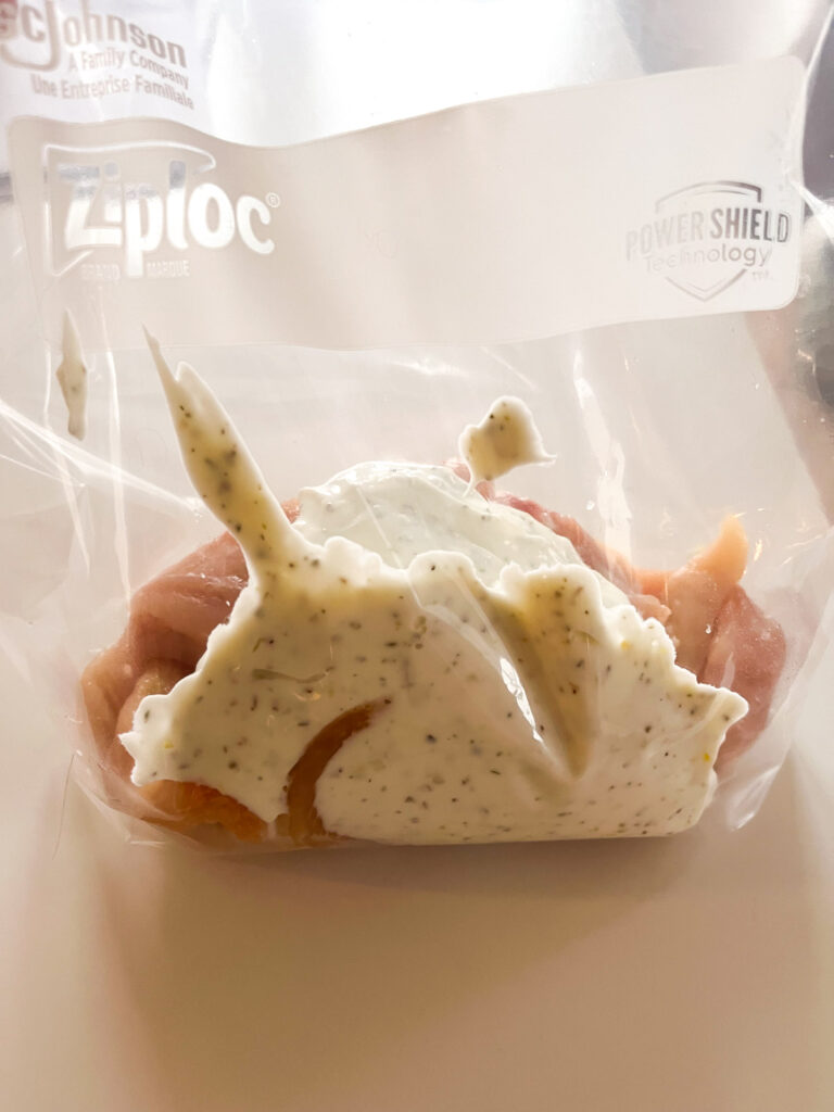 Add greek yogurt marinade to ziplock bag filled with chicken.