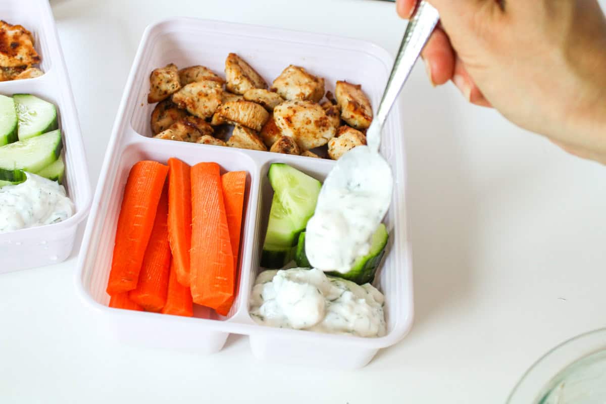 Adding dip to the bento boxes.