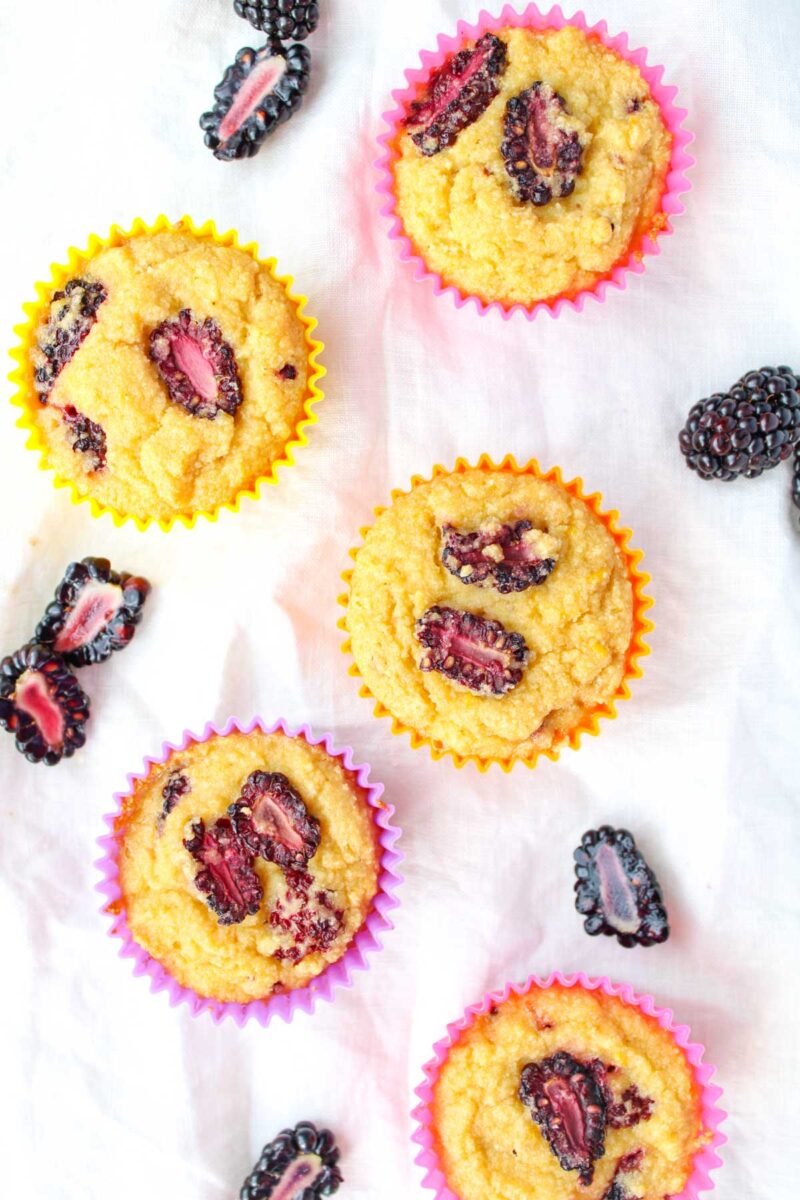 Blackberry muffins on a white tablecloth. 