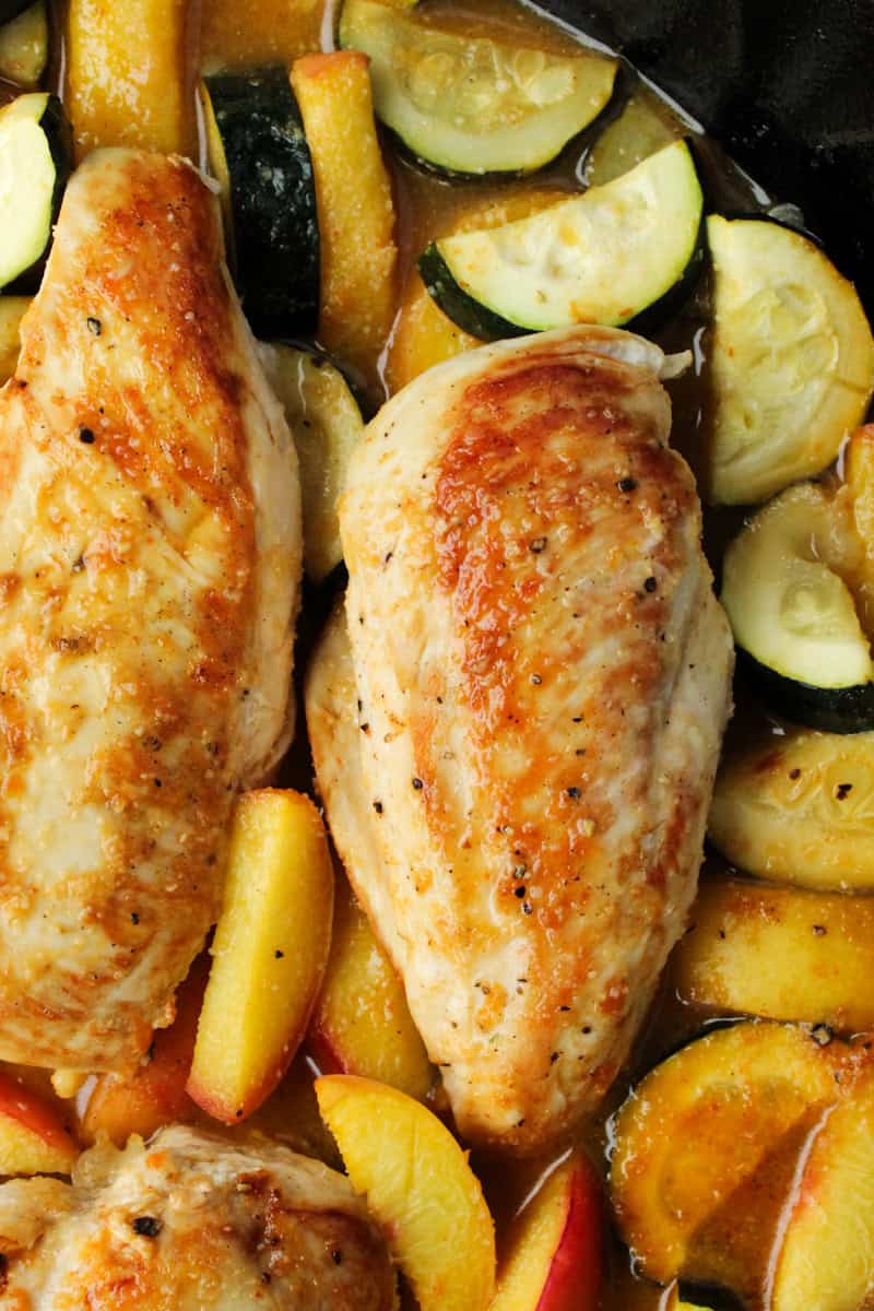 Baked Chicken with Zucchini and Peaches in a pan.