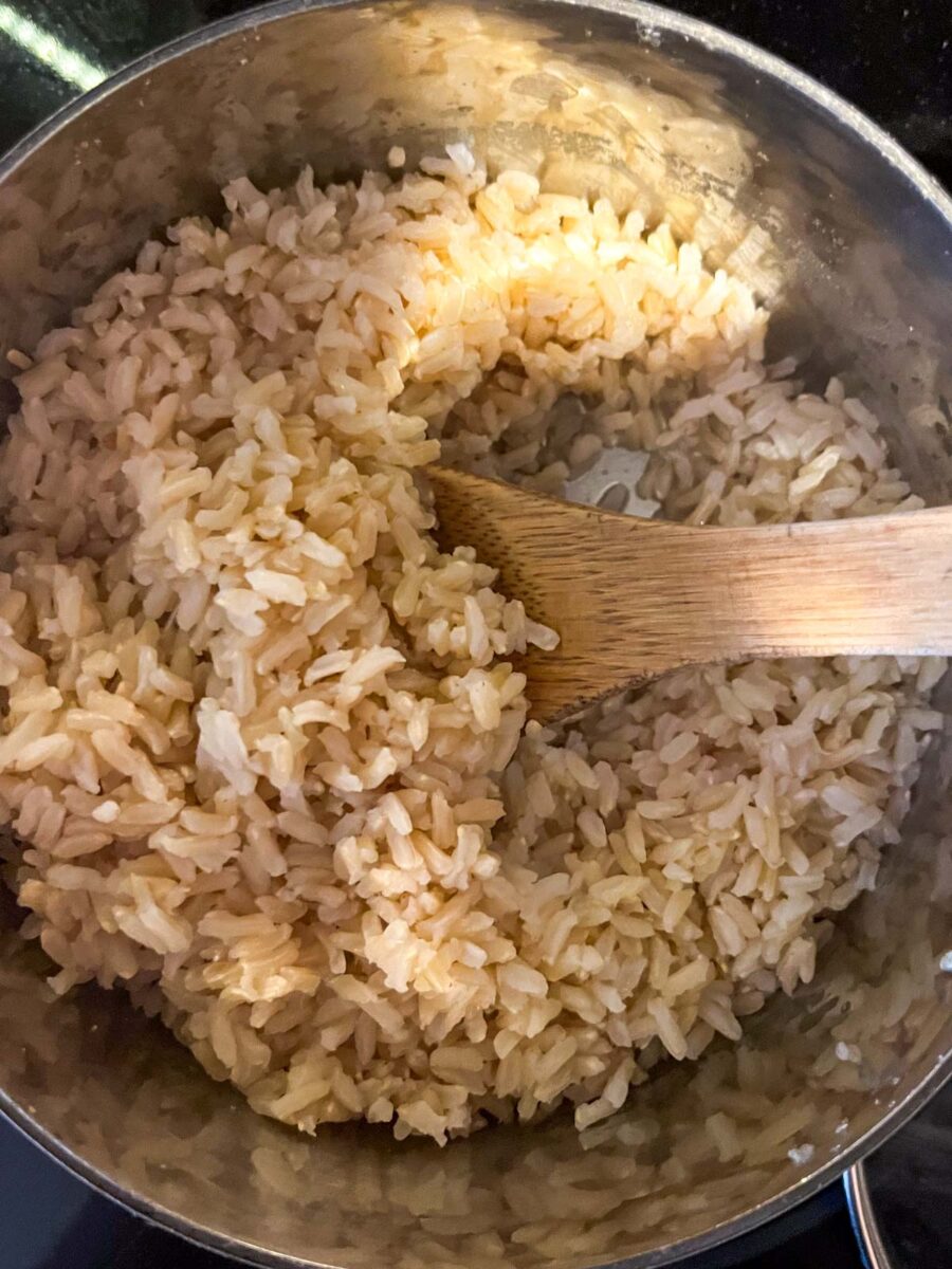 Cooked brown rice in a small pot.