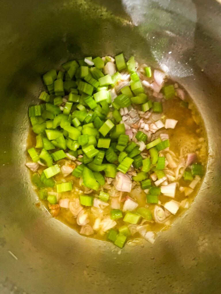 Onion and celery in an Instant Pot.