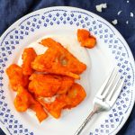 Buffalo Cauliflower Wings on a white and blue plate and a silver fork beside