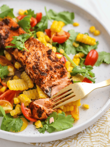 Cajun Salmon on a white plate with Corn Salsa.