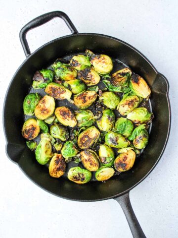 Cut brussel sprouts in a cast iron pan.