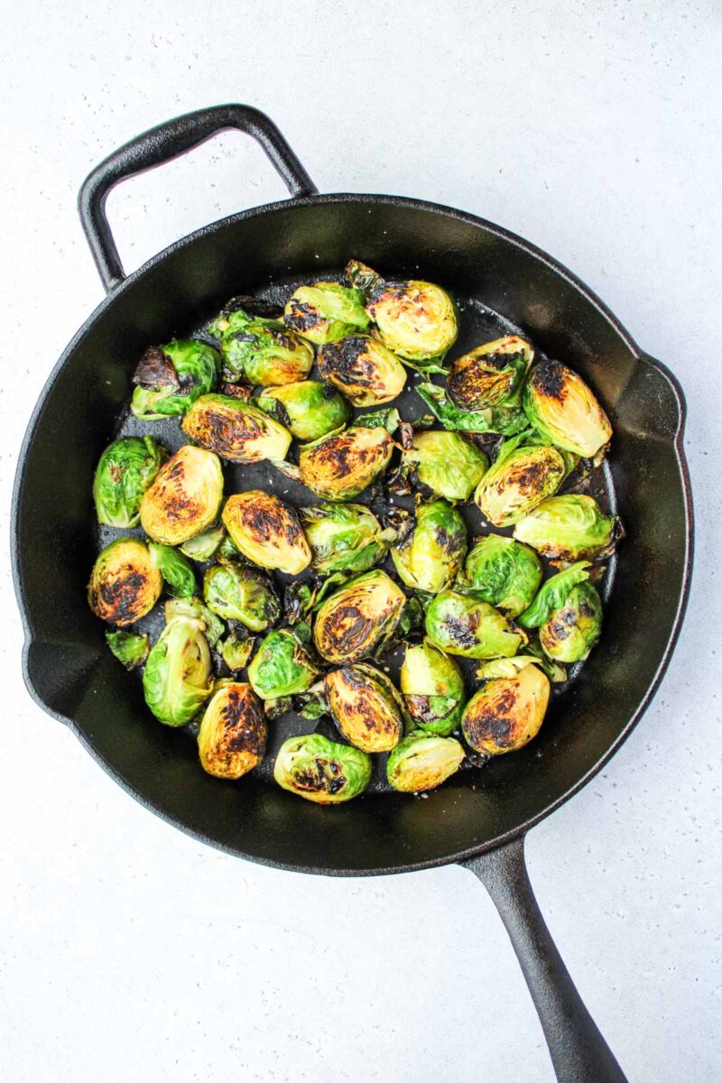 Cut brussel sprouts in a cast iron pan.