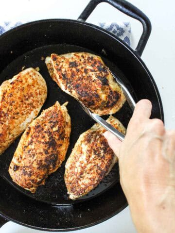 Chicken Breasts in a cast iron skillet.