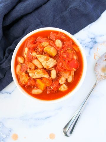 Chicken Soup with Tomatoes in a small white bowl
