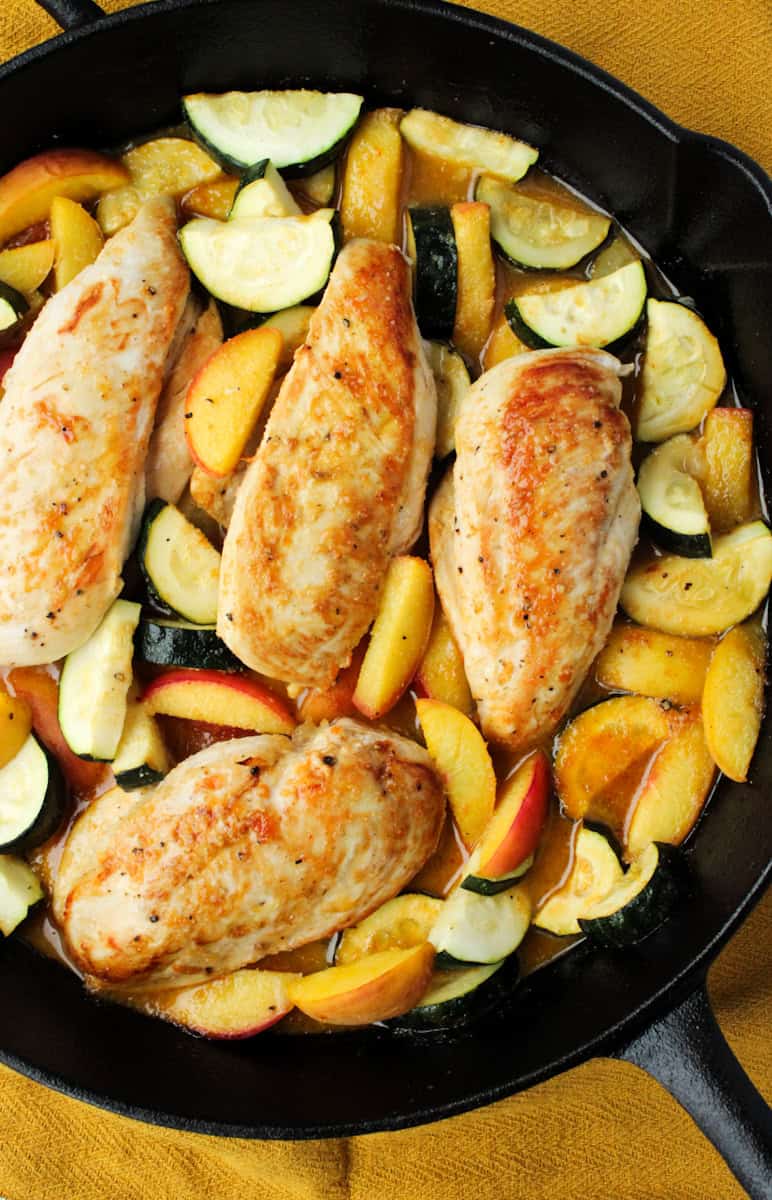 Chicken with Zucchini and Peaches in a cast iron pan.