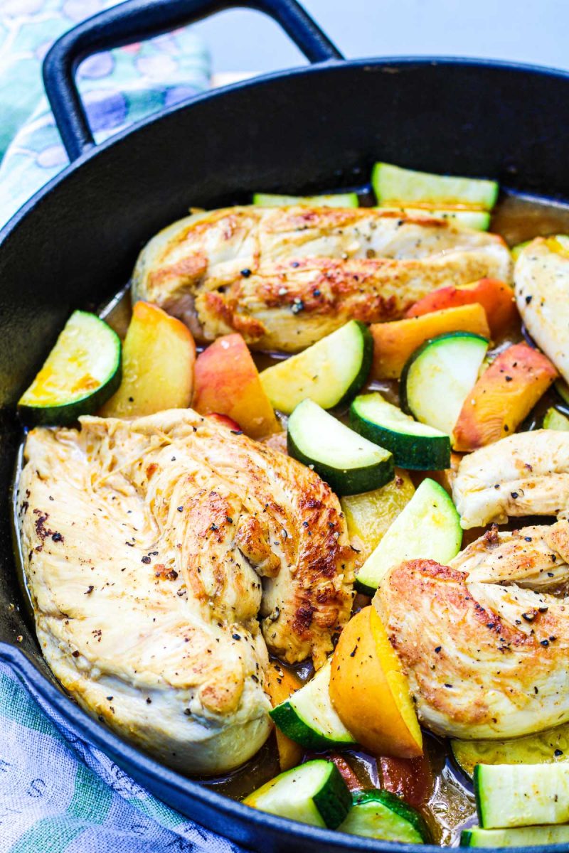 Chicken zucchini and peaches cooked in a castiron skillet