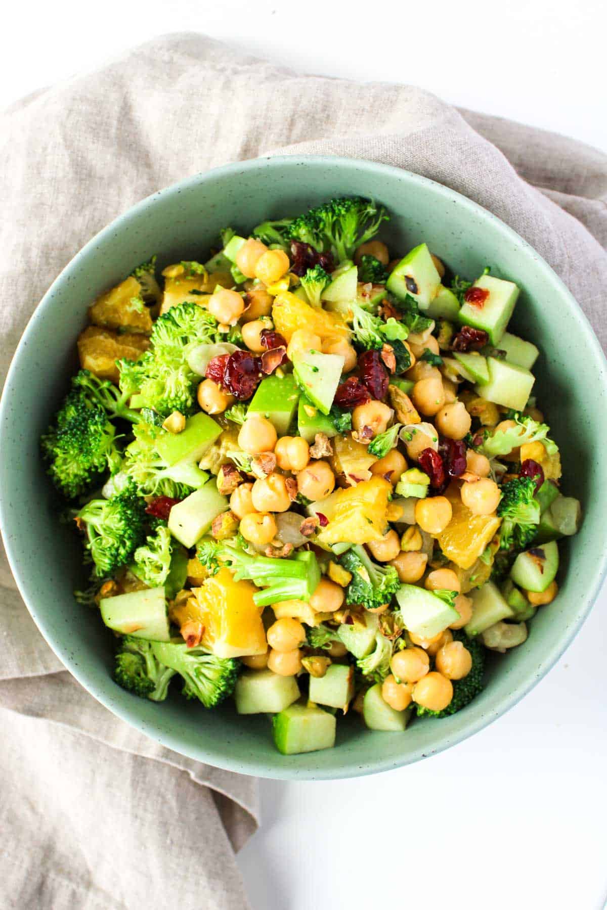 Healthy chopped Chickpea Salad with Oranges and Mint in a green bowl.
