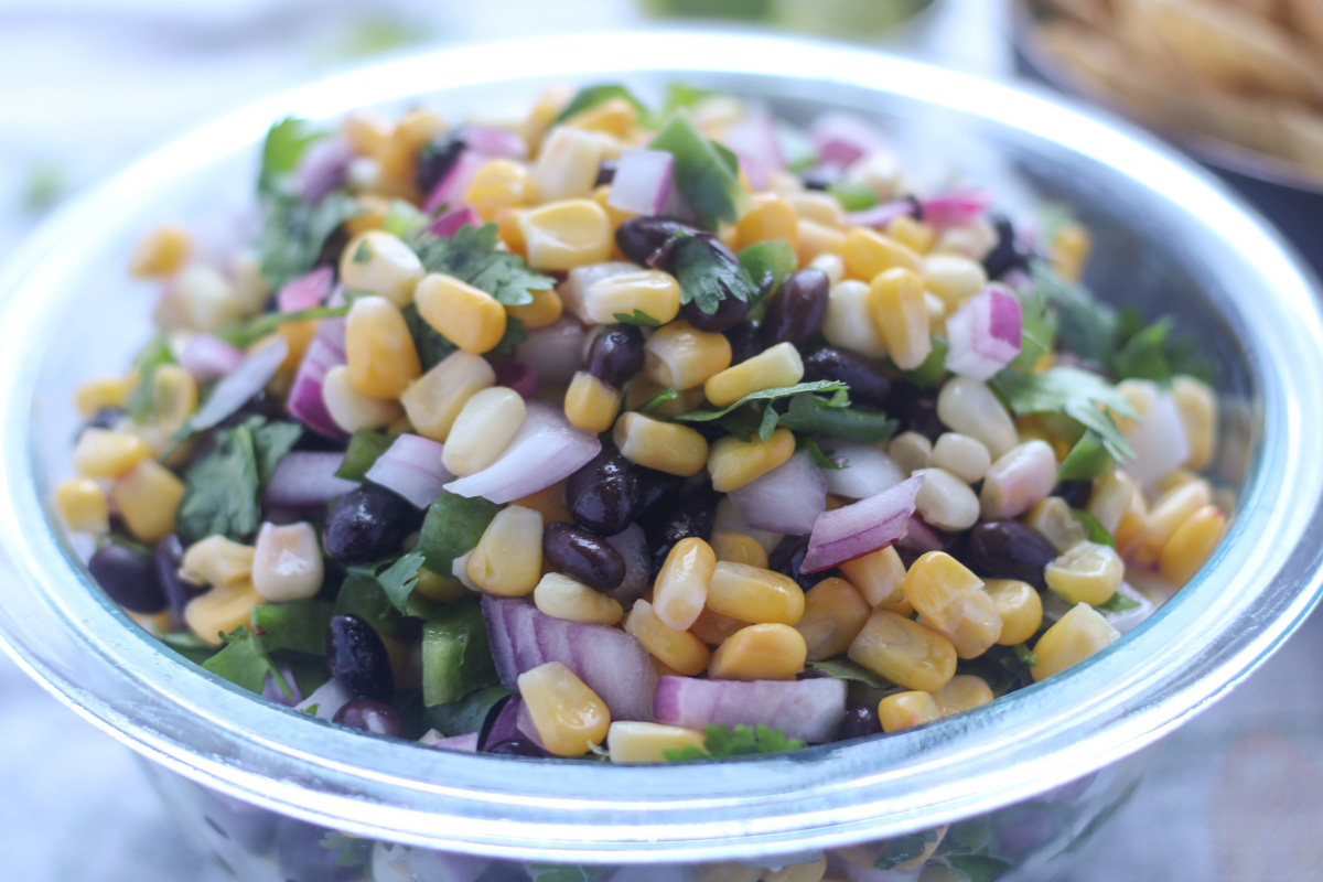 Close up shot of Summer Corn and Black Bean Salsa in a clear glass bowl