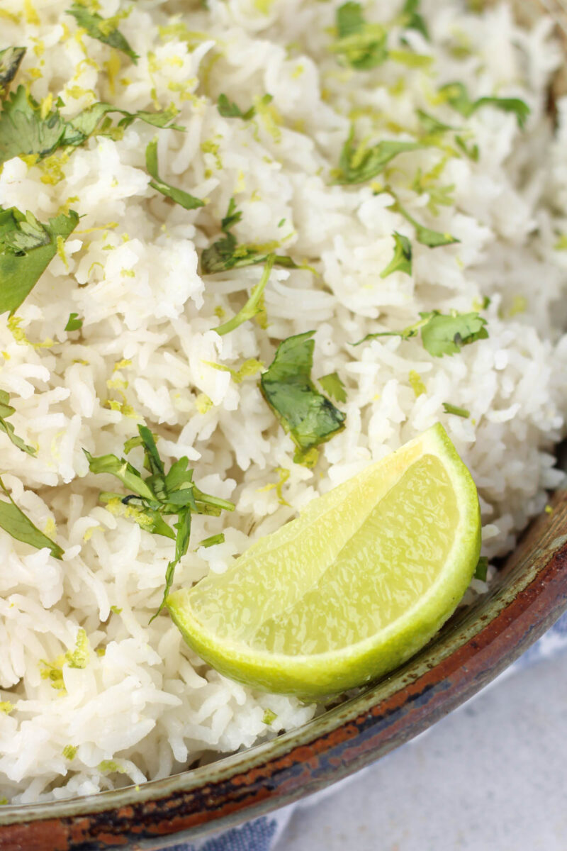 Cooked rice in a dish with lime.