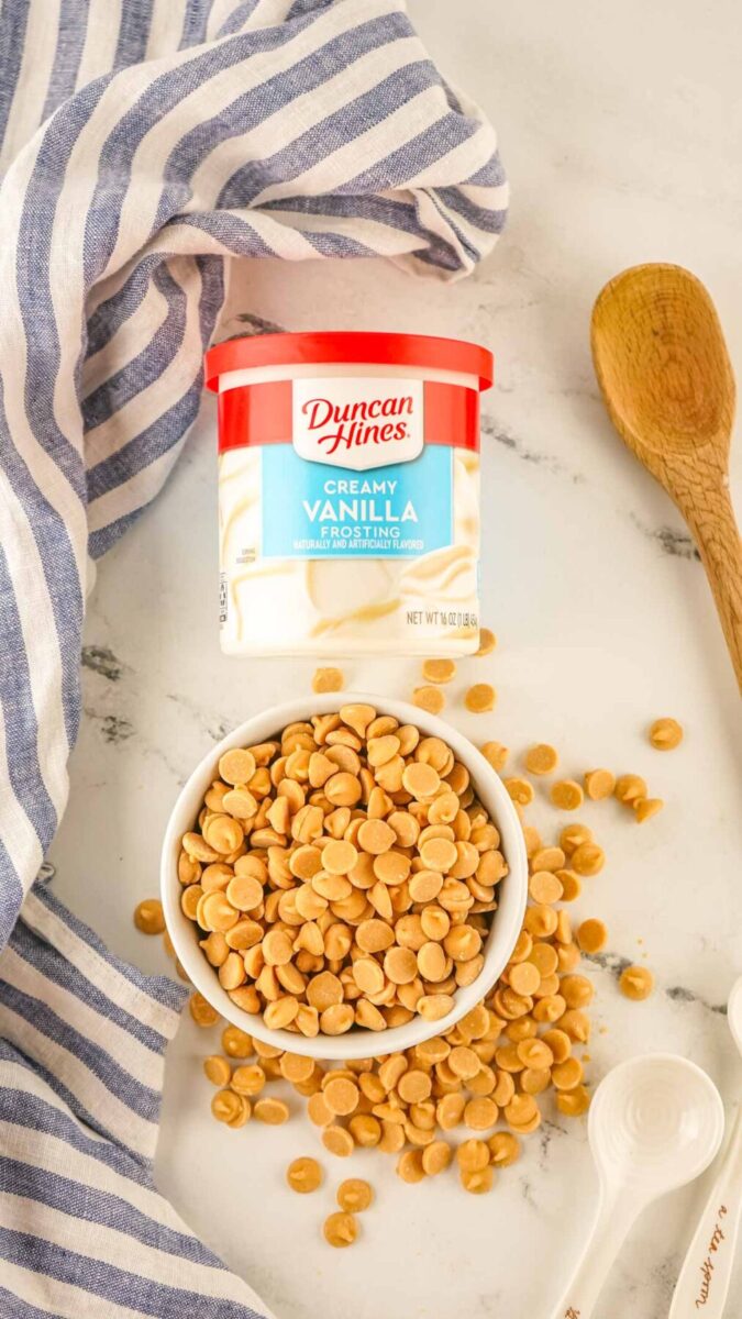 White icing and peanut butter chips in a bowl.