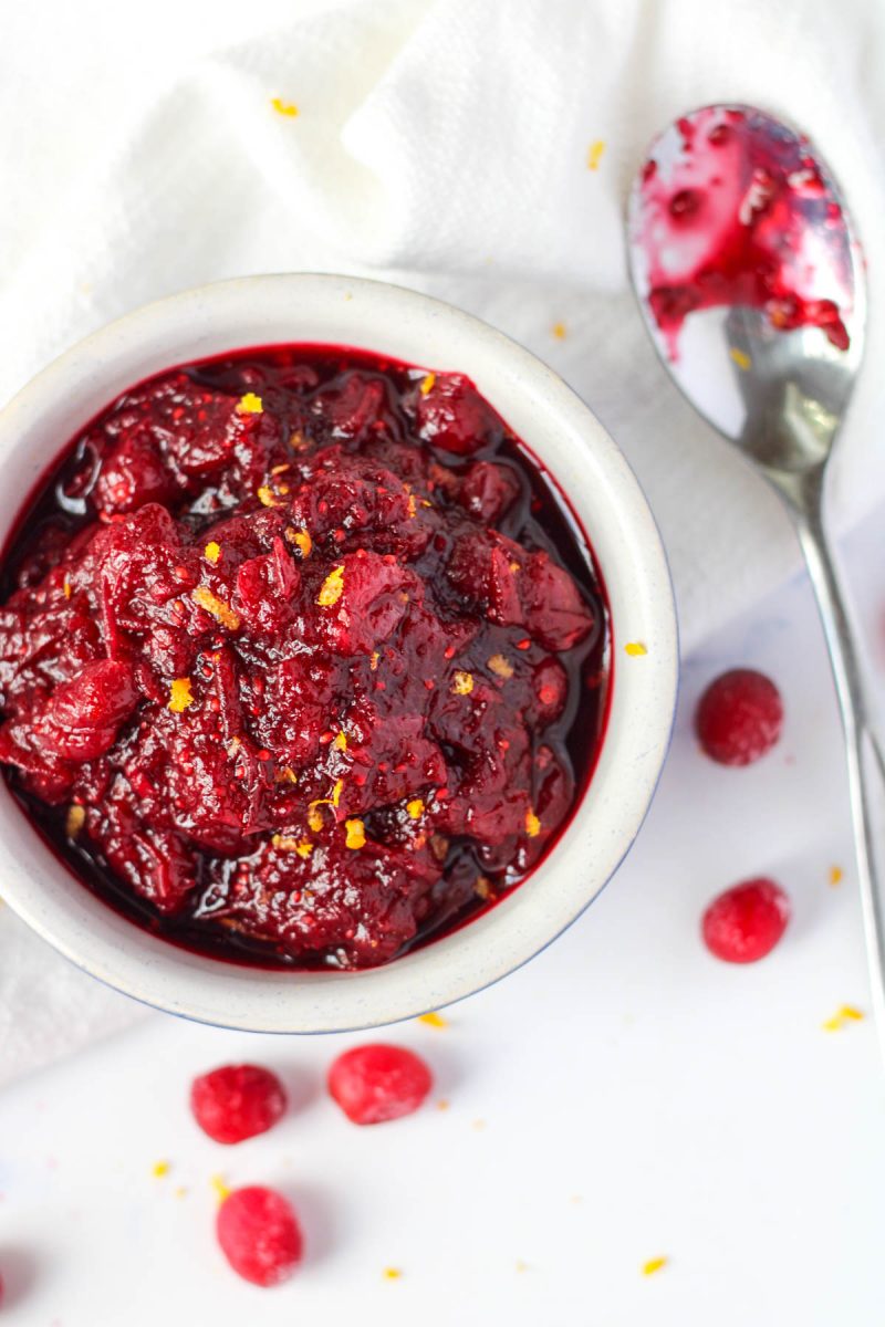 small bowl of Cranberry Pomegranate Sauce with a spoon