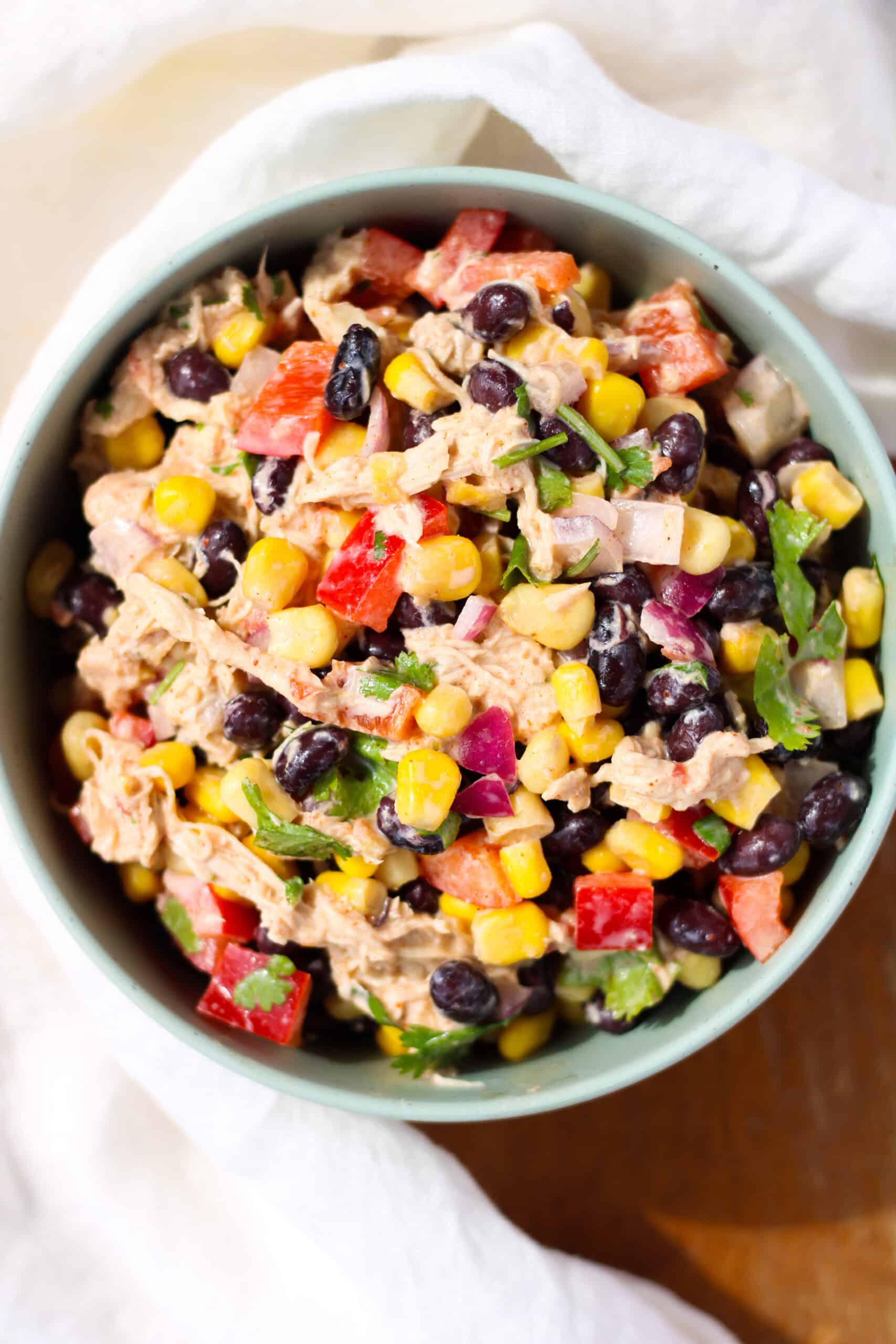 Creamy Chicken Black Bean and Corn Salad in a green bowl.
