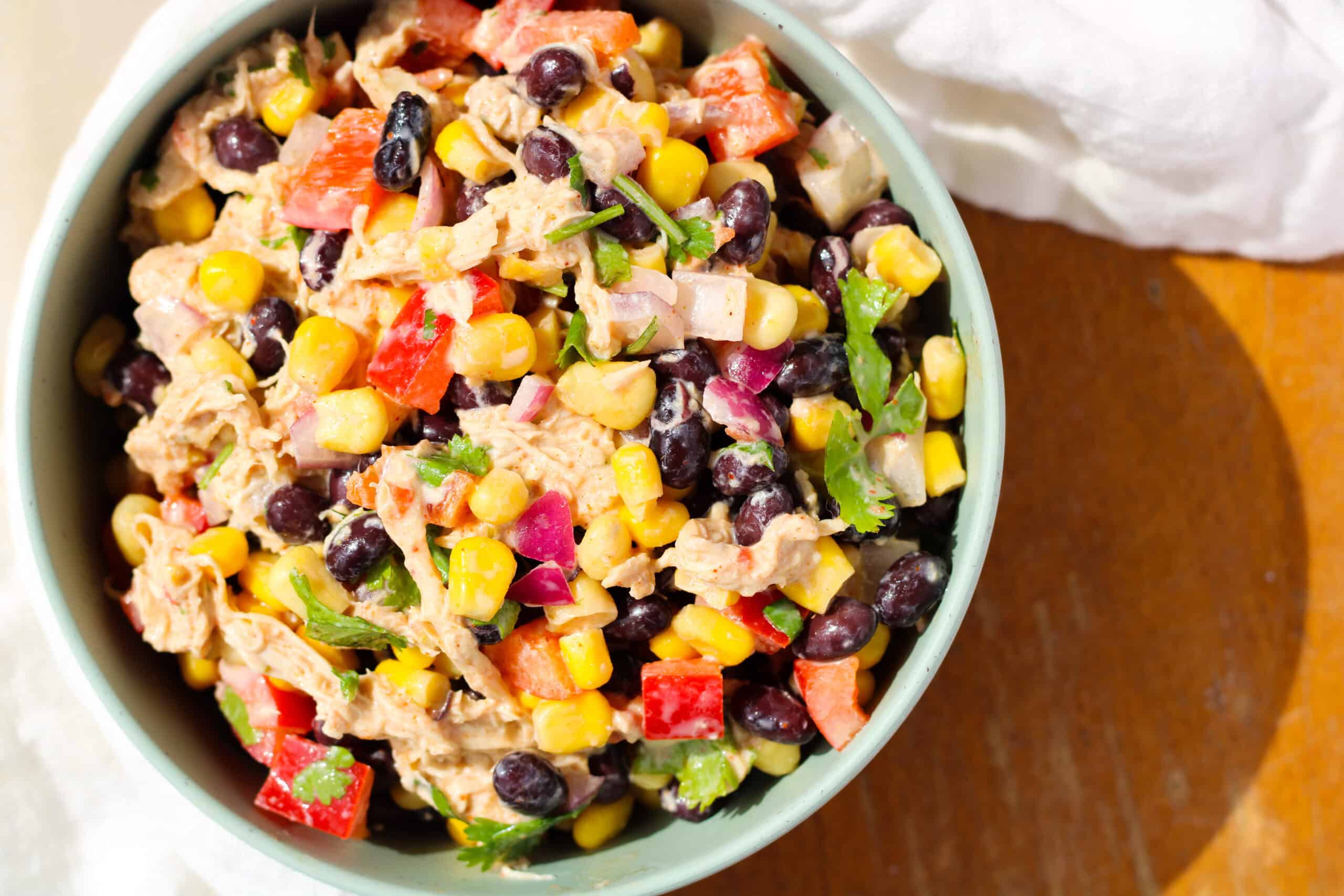 Creamy Chicken Black Bean and Corn Salad in a green bowl.