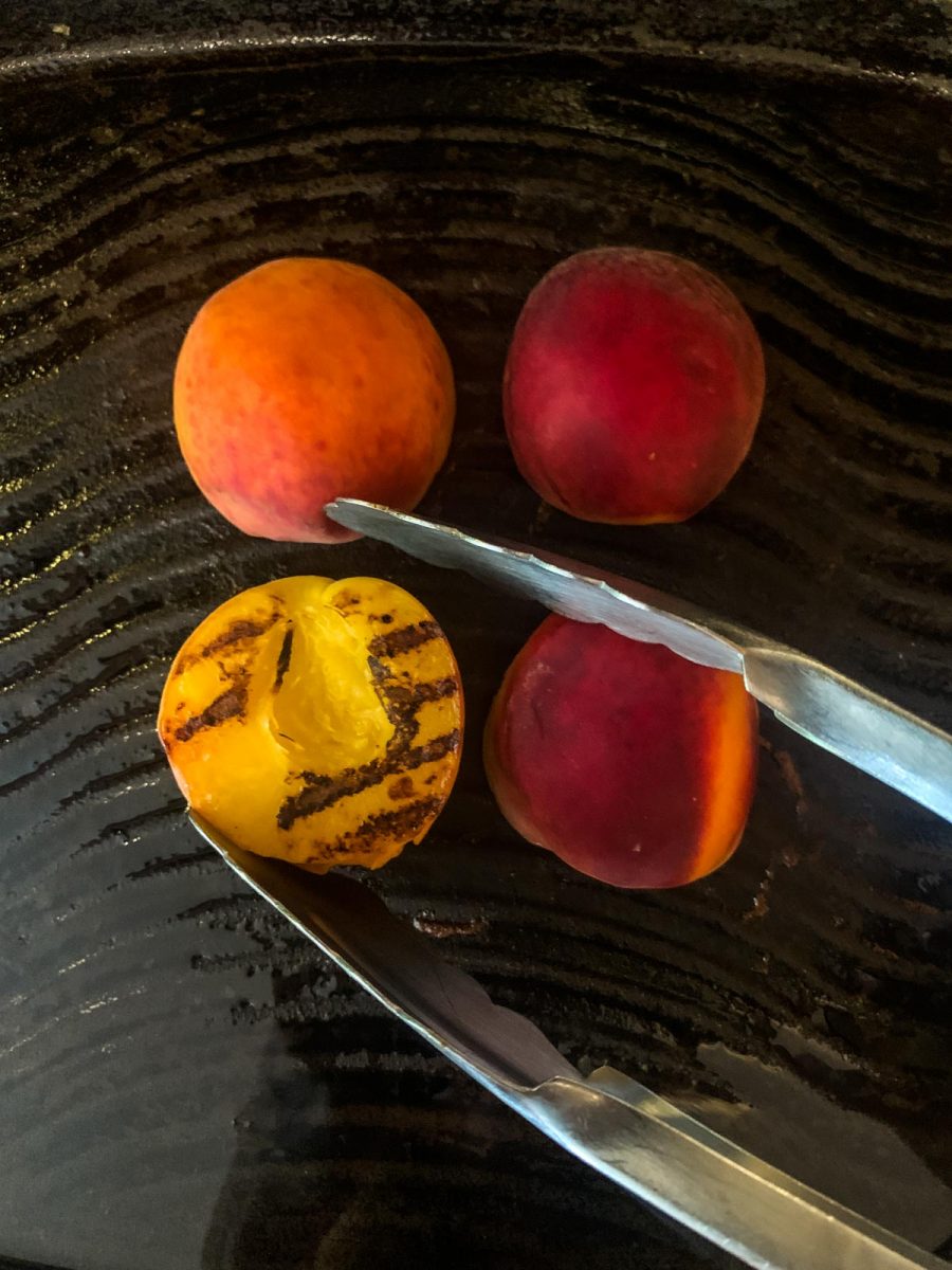 4 peach halves on a grill pan.