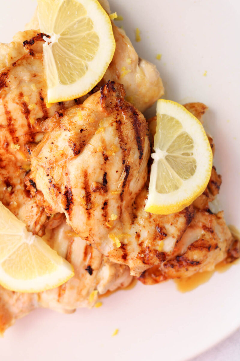 A plate of lemon marinated chicken on a white plate.