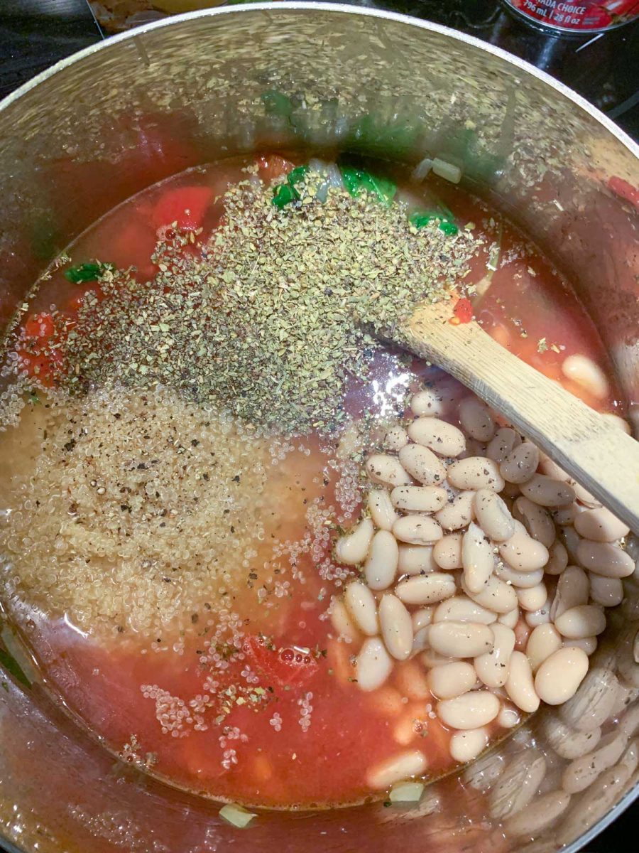 Large soup pot showing beans, spices, quinoa and tomatoes.