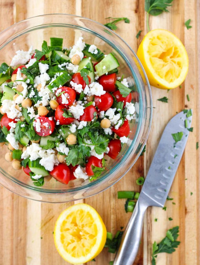 Fresh Herb Salad with Chickpeas and Feta in a clear white bowl