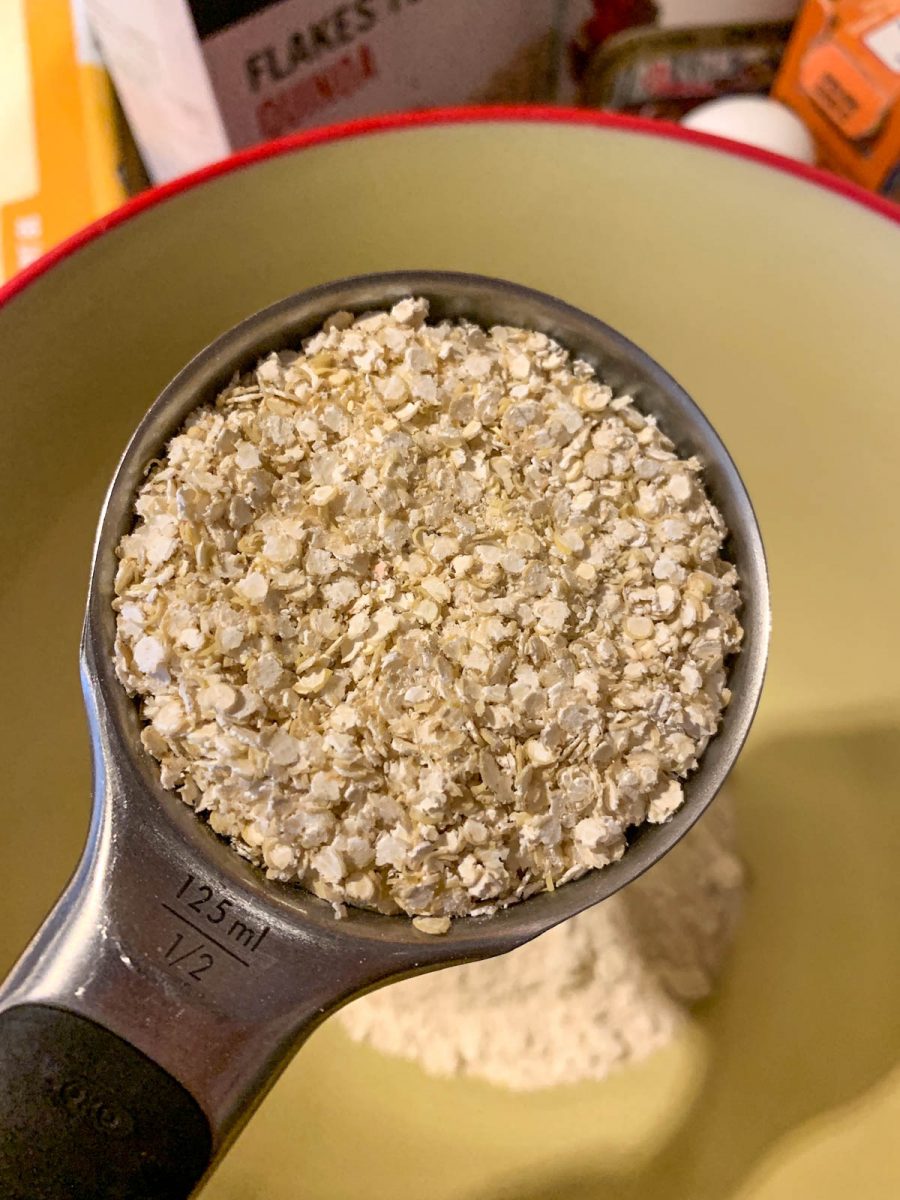 A measuring cup filled with quinoa flakes