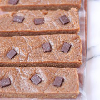 Homemade energy bars with chocolate chips on a white countertop