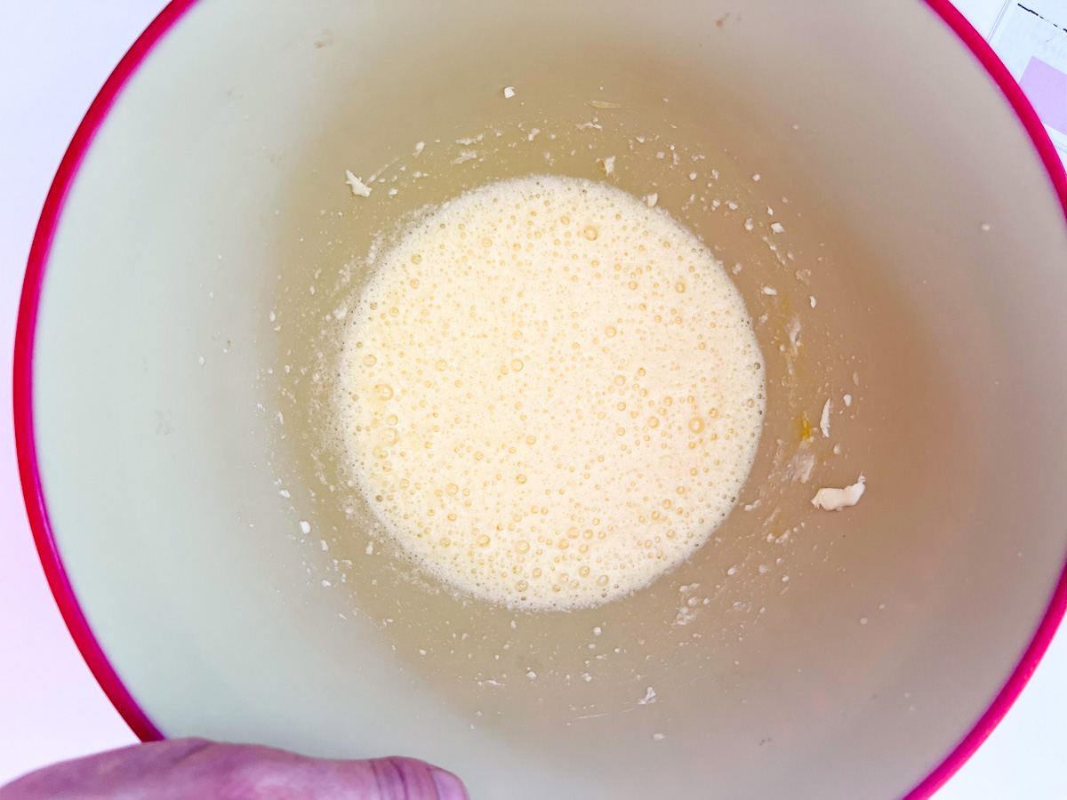 Wet ingredients blended for pumpkin cookies in a mixing bowl.