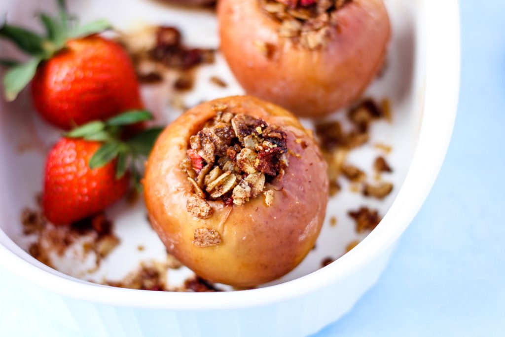 a baked apple filled with oat and strawberry filling