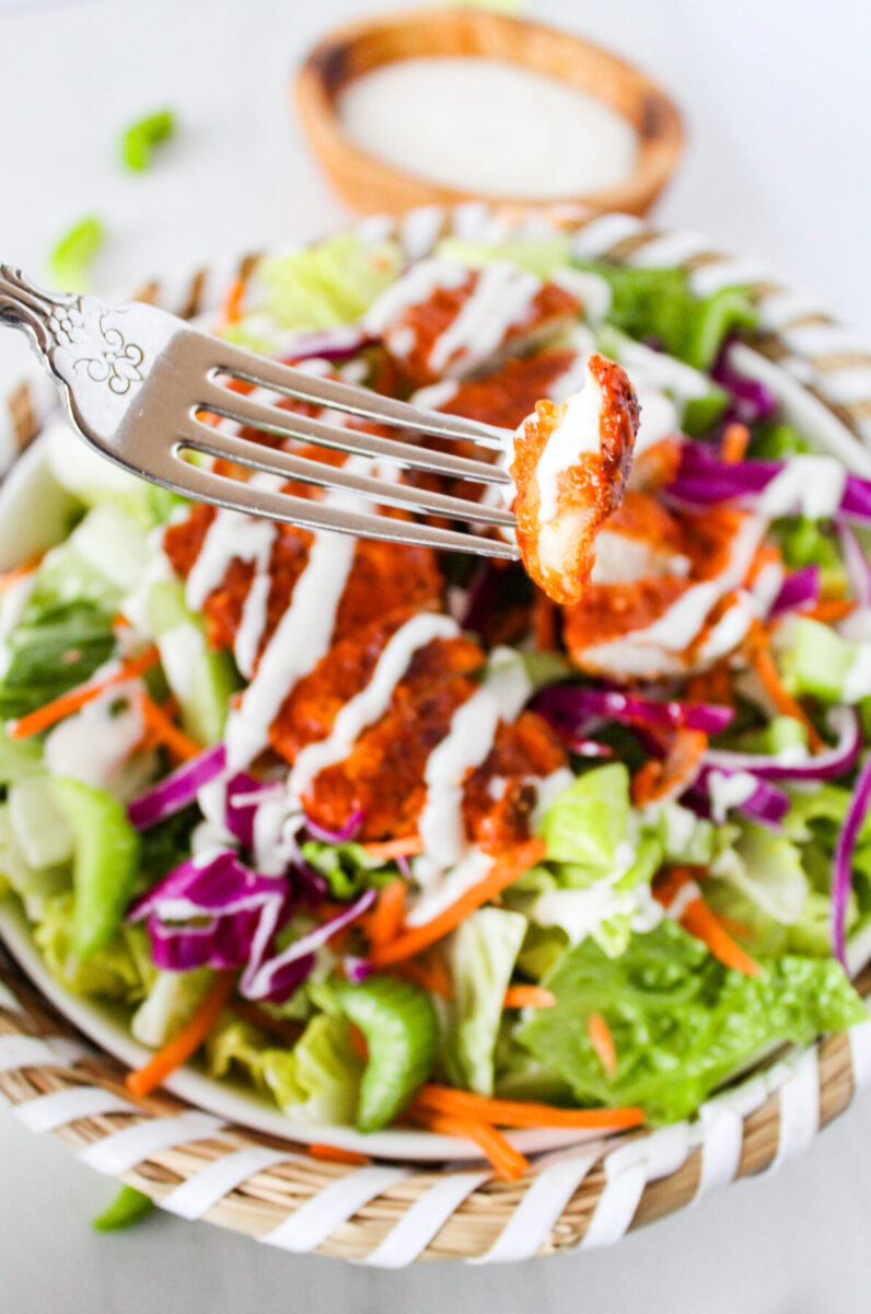 Buffalo chicken salad with a fork.