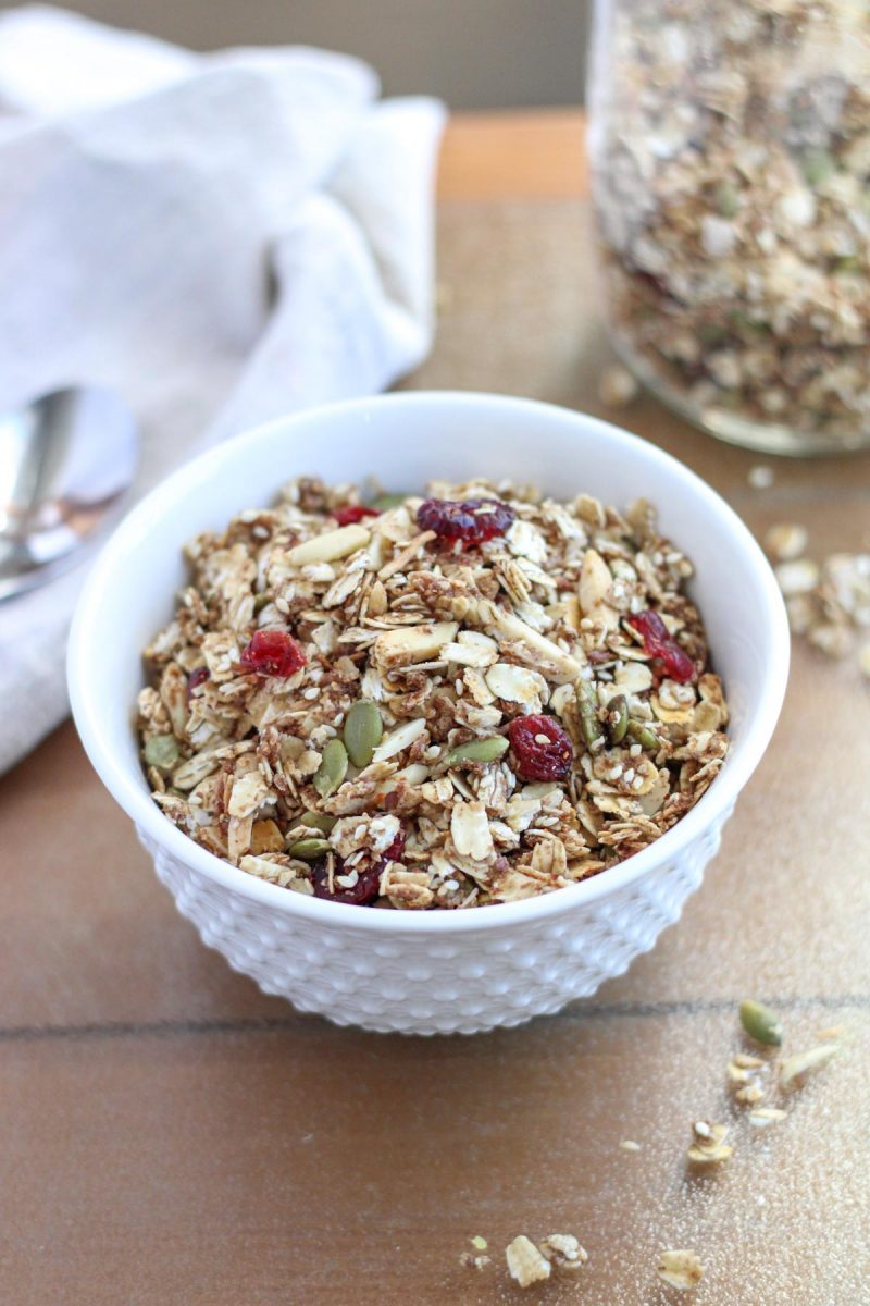 Healthy Gluten Free Granola in a white bowl on a brown table top