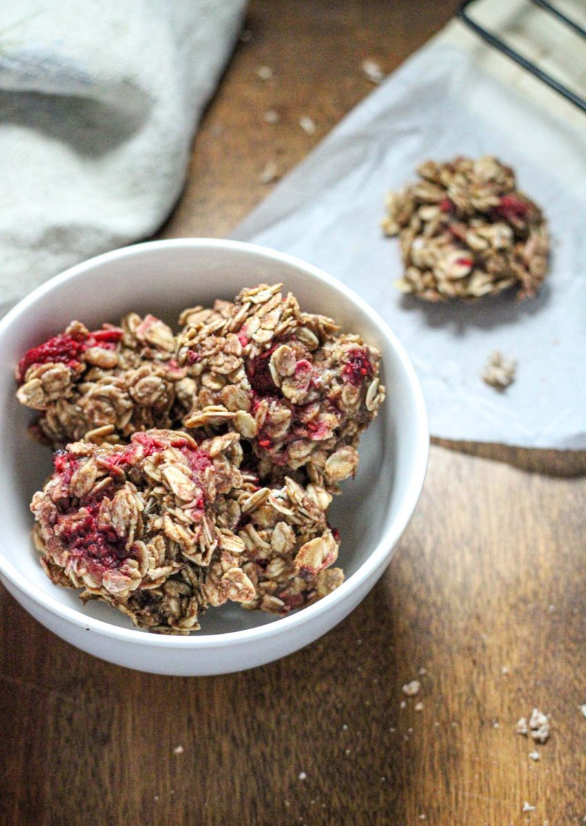 Healthy Peanut Butter Oatmeal Raspberry Breakfast Bites in a white bowl on a wood tabletop