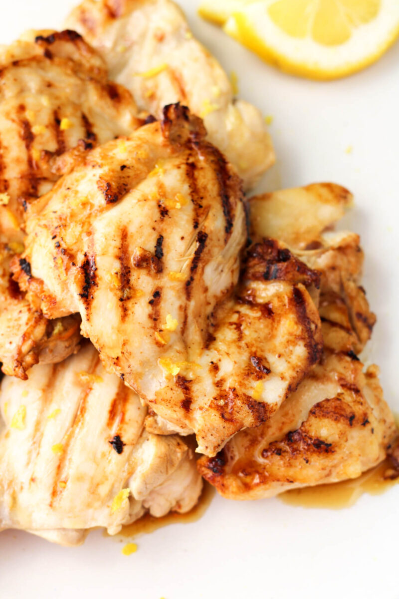 A plate of lemon marinated chicken on a white plate.