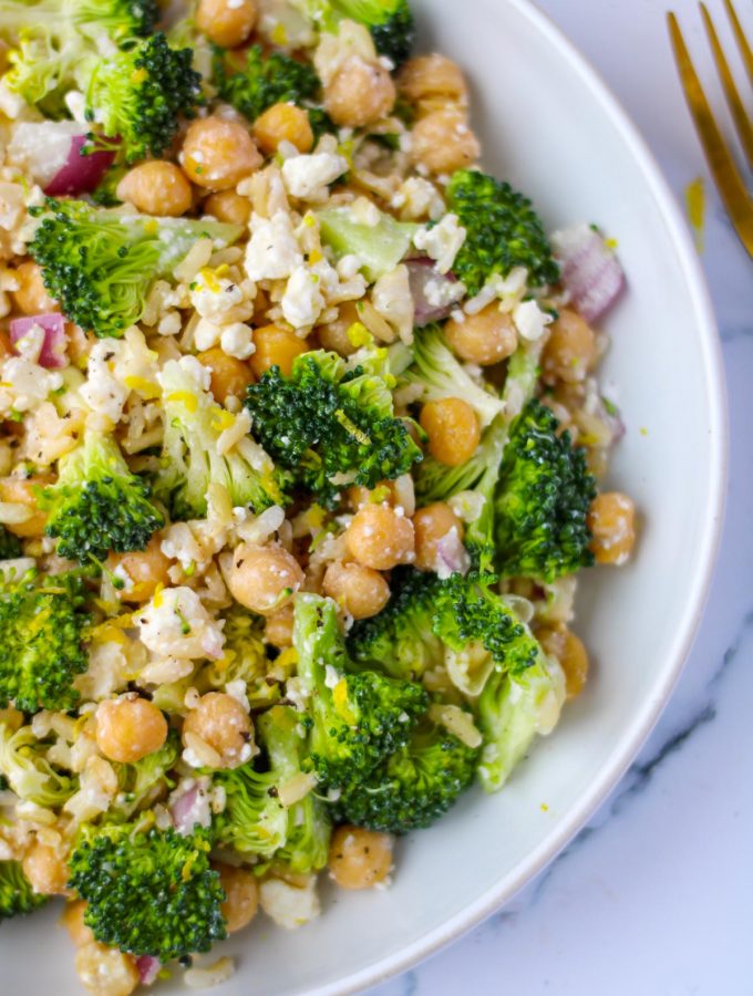 A large white dish filled with Brown Rice, Broccoli and Feta Salad