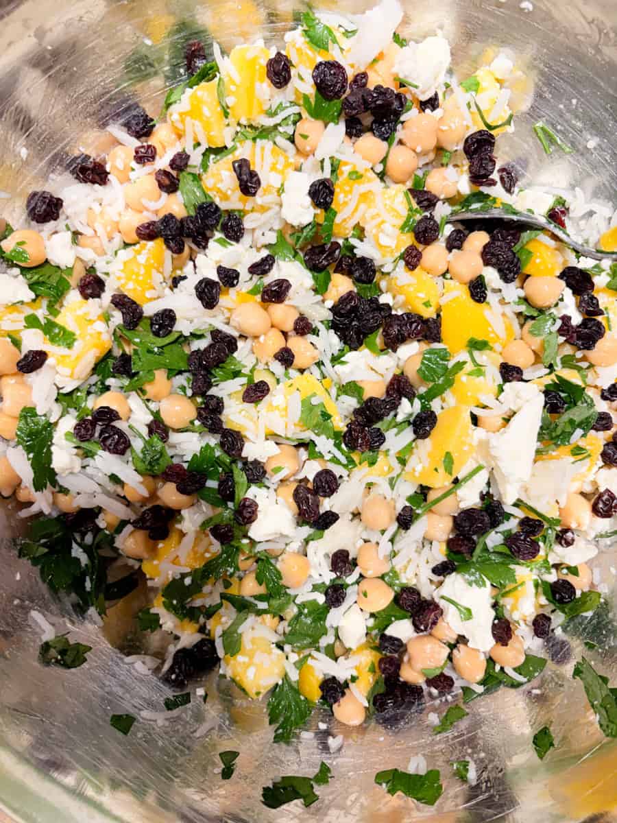 Chickpea and mango salad with herbs, blackberries, and cheese, perfect for a nutritious salad.