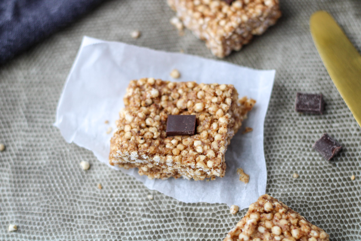 One Puffed Quinoa Bars with Almond Butter on a small piece of parchment paper