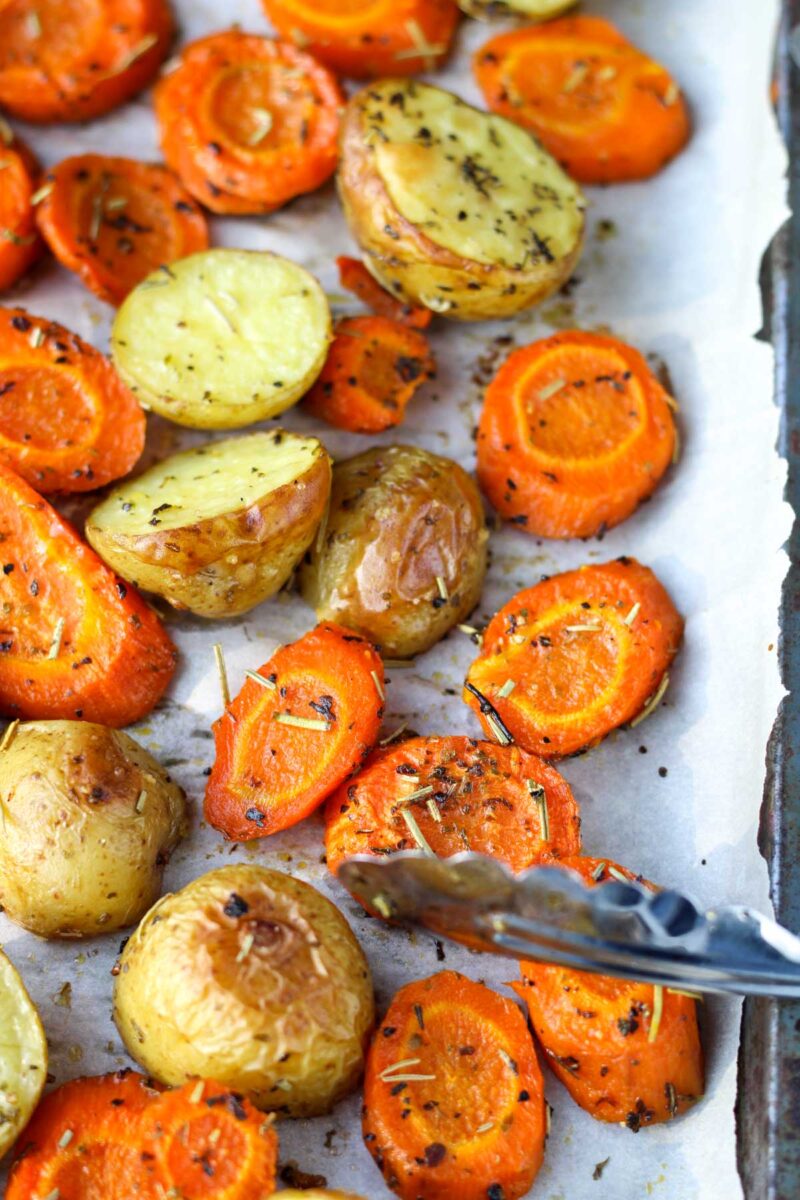 Oven Roasted Potatoes and Carrots on parchment paper.