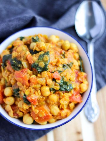 Overhead shot of a chickpea curry with Spinach in a blue bowl