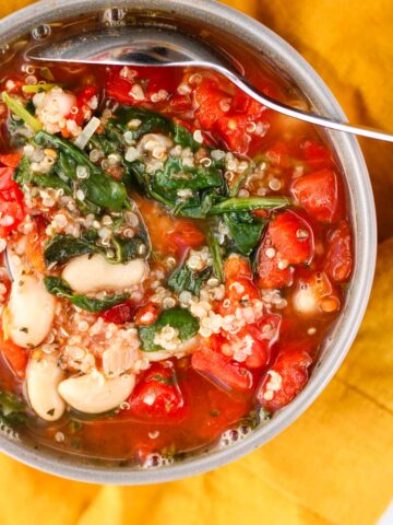 Bowl of Quinoa Spinach Soup and Tomatoes with white beans.
