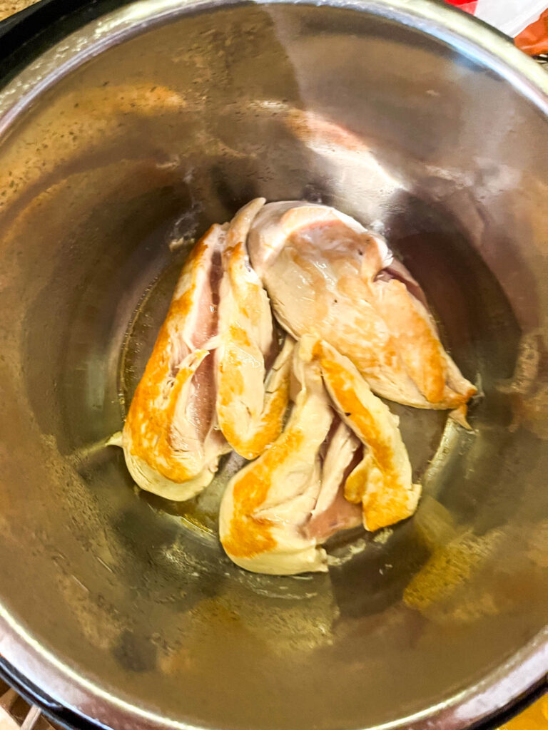 Browning chicken breasts in an Instant Pot.