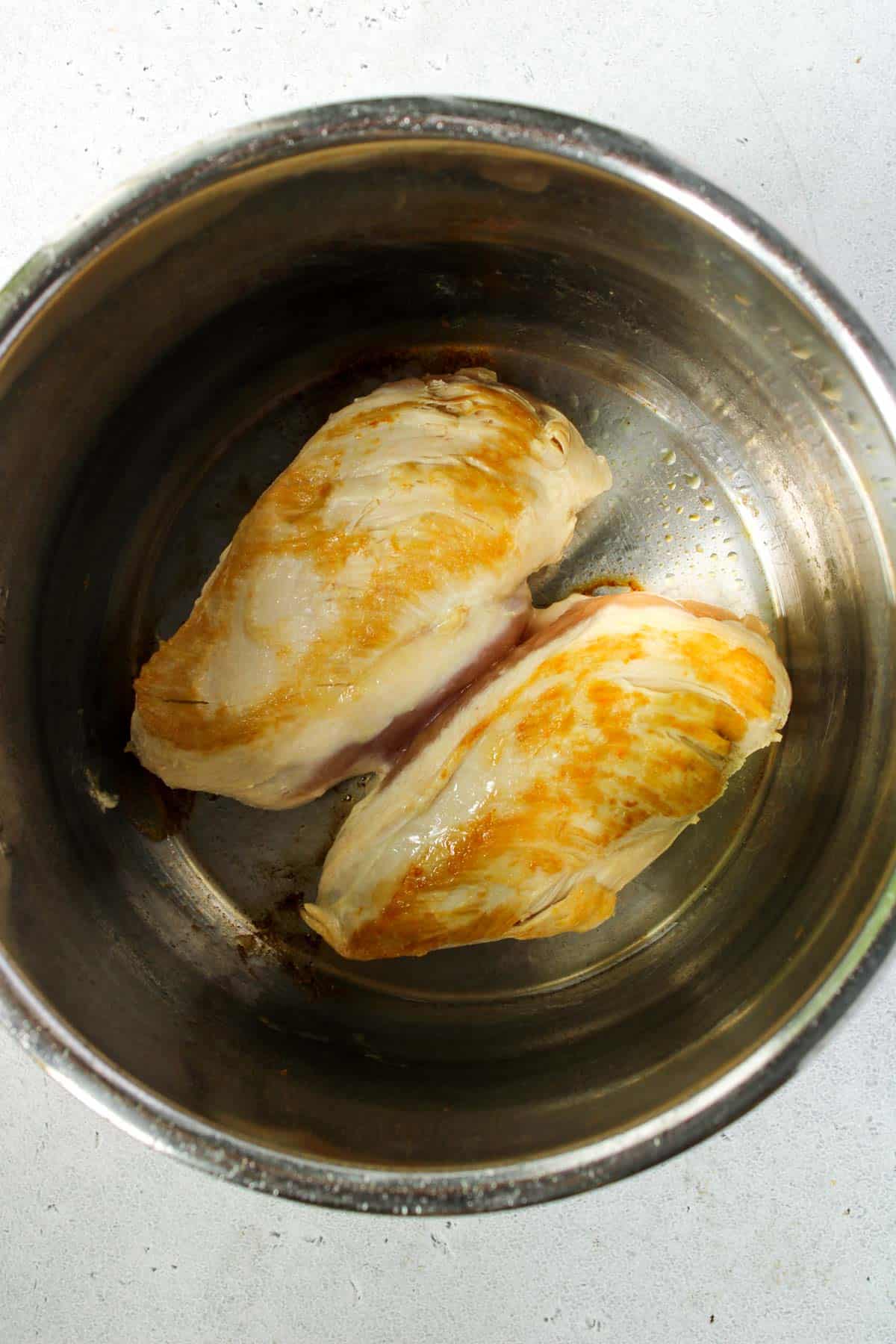Searing 2 chicken breasts in an Instant Pot.