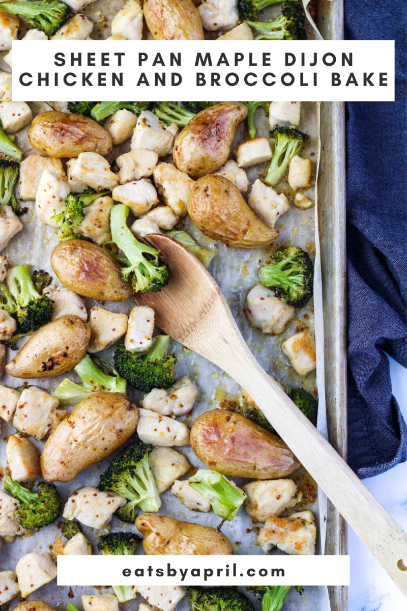 Sheet Pan with broccoli, chicken and potatoes with a wooden spoon in it