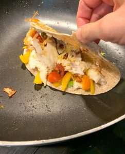 Showing the inside of a Simple Haddock Quesadillas-look at the melted cheese