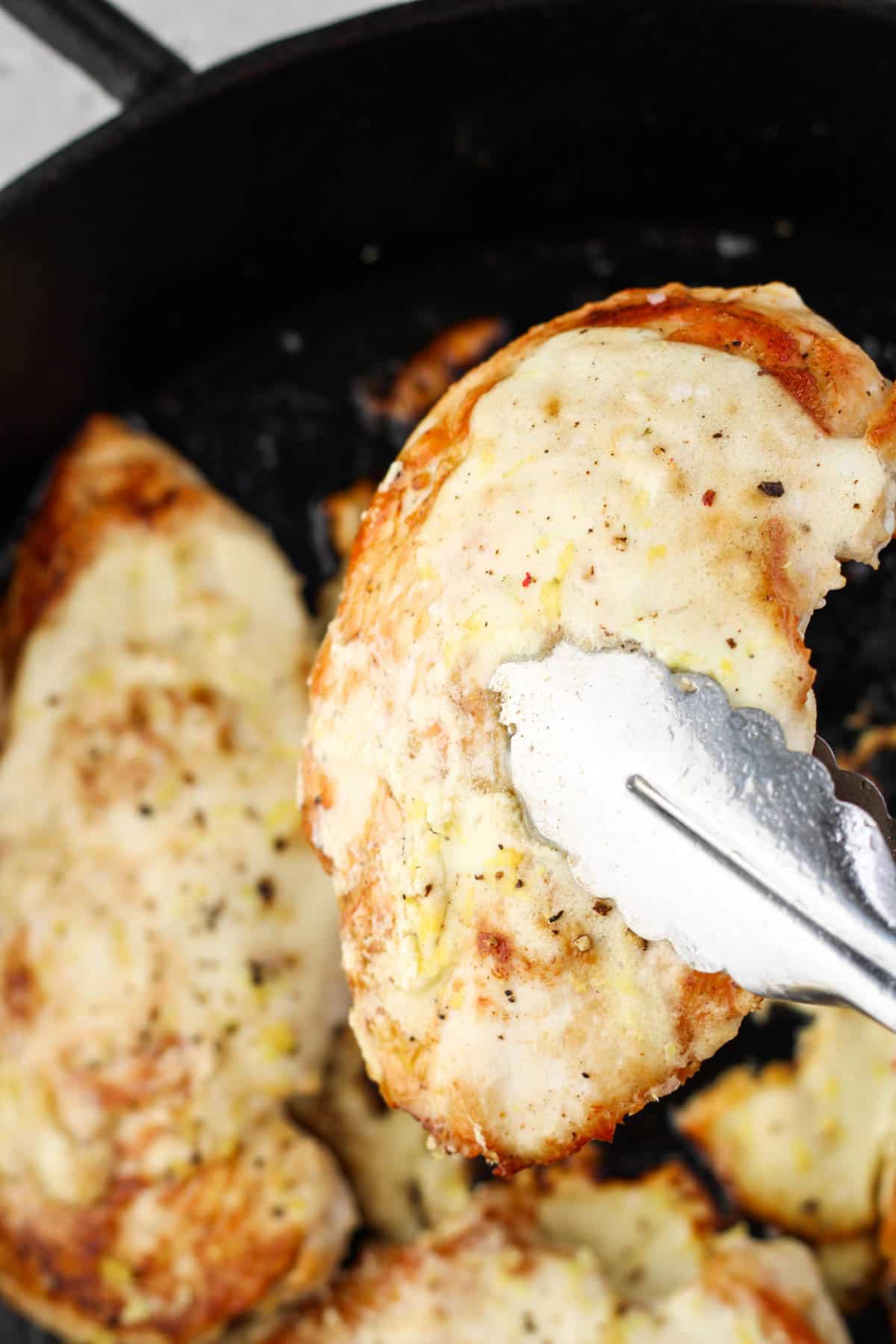 Chicken breasts in a cast iron skillet.