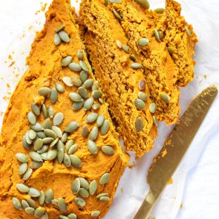 slices of pumpkin bread with a gold knife beside