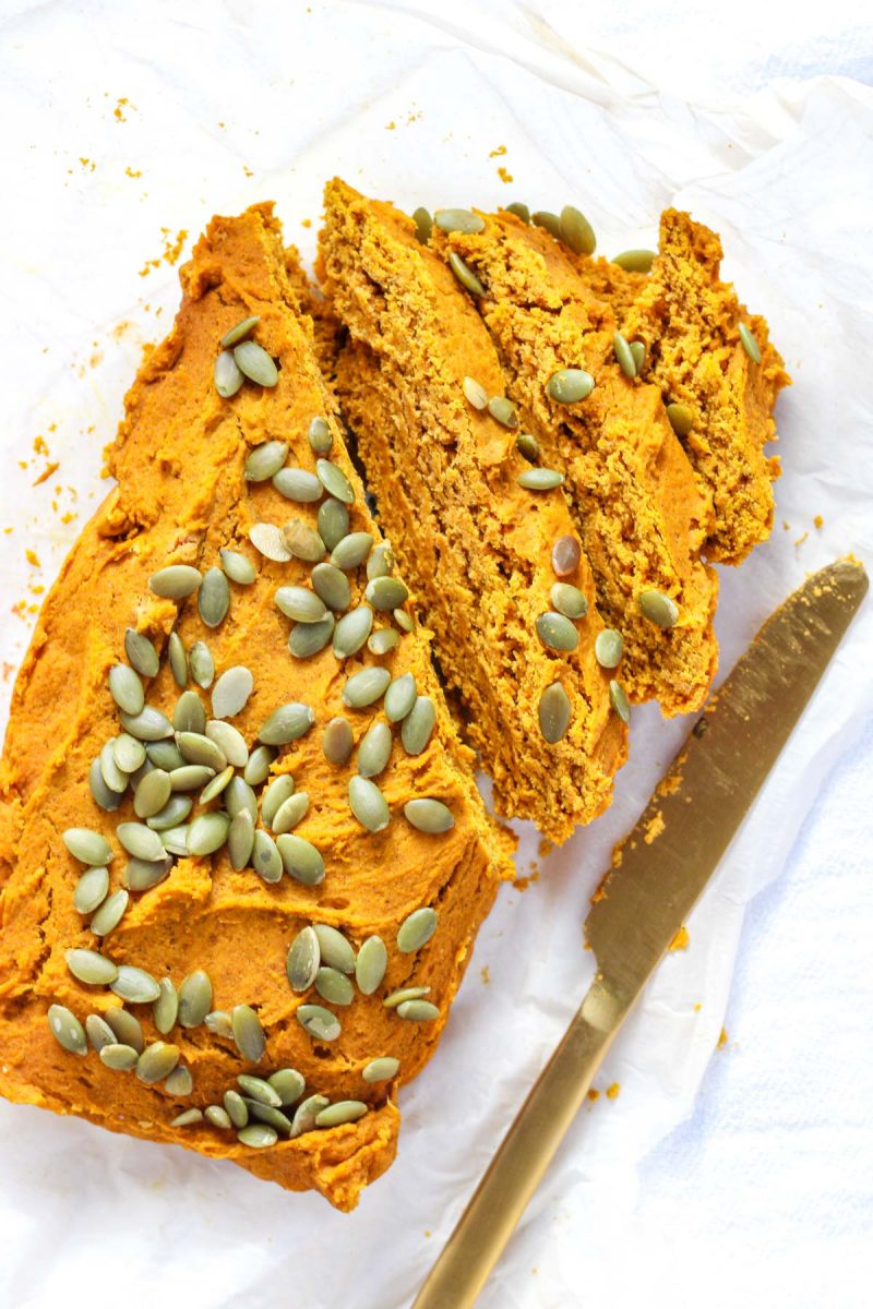 slices of pumpkin bread with a gold knife beside